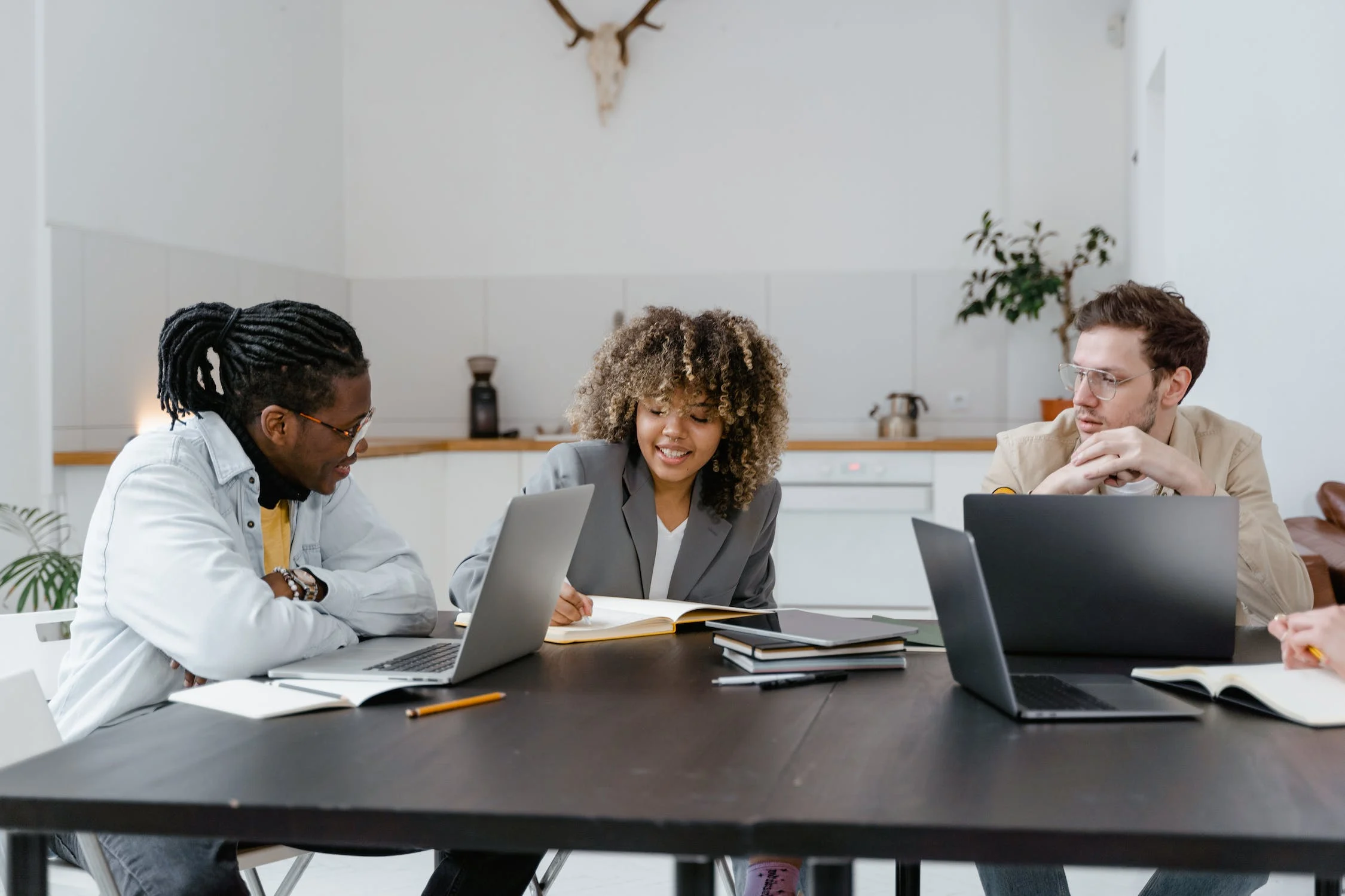 Co-workers are seen collaborating on business analytics in an office setting. 